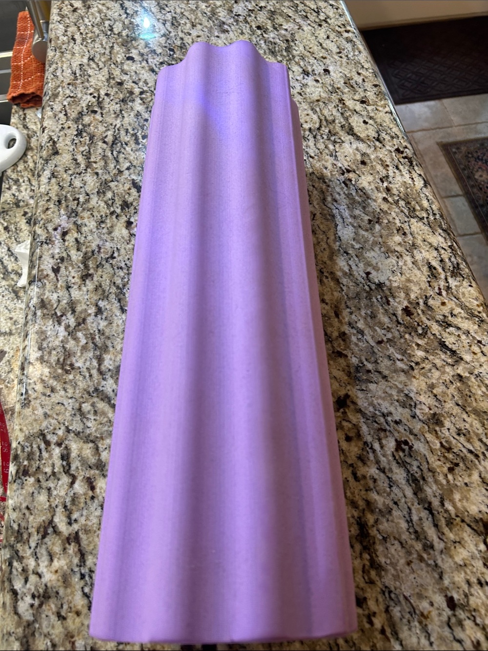 Ribbed foam roller featuring a textured fluted surface for deep-tissue massage